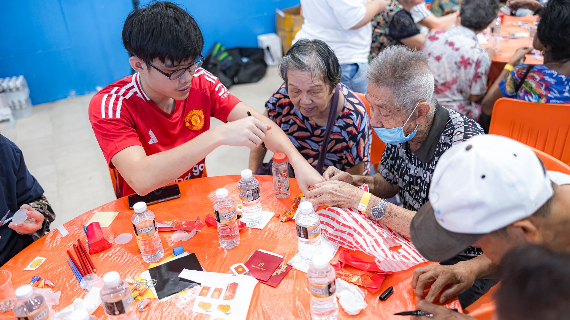 Interacting with a group of elderly residents over an arts and craft activity during a Chinese new year community event. | Donovan Lim's Portfolio | Gengen
